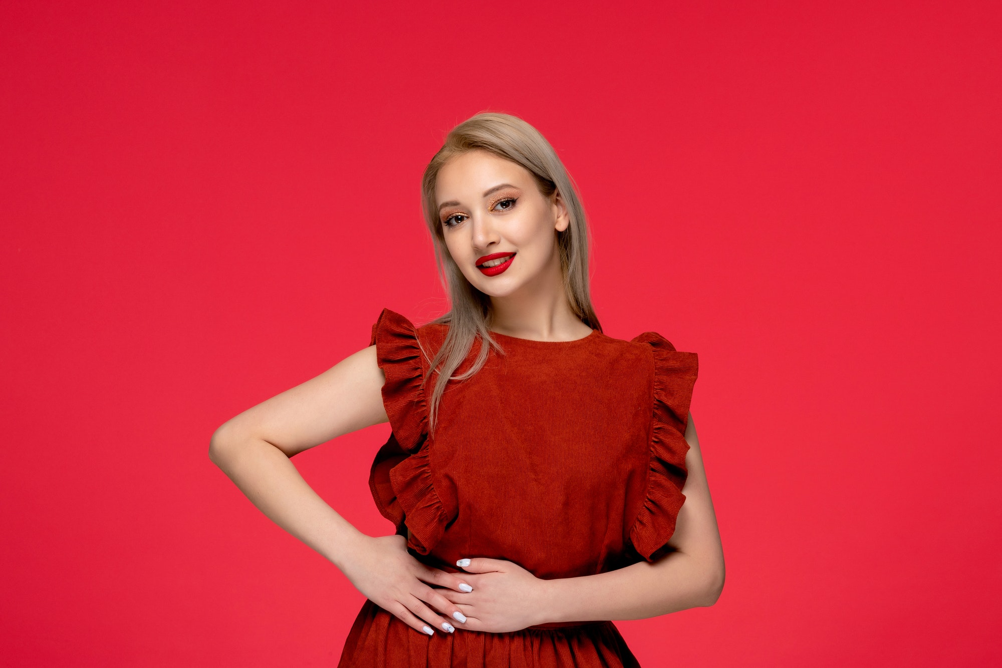 red dress elegant cute young woman wearing burgundy dress with lipstick on red wallpaper
